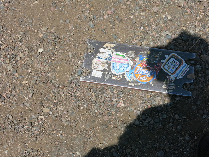 An auto part covered with stickers lays in the dirt at the Kansas/Colorado border.